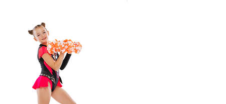 Cropped portrait of beautiful little girl, cheerleader in colorful costume with pom-pons training...