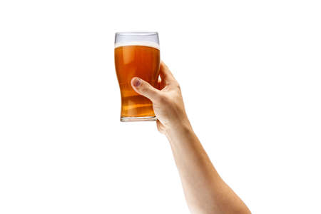 Cropped image of male hand holding glass of lager foamy beer isolated over white background