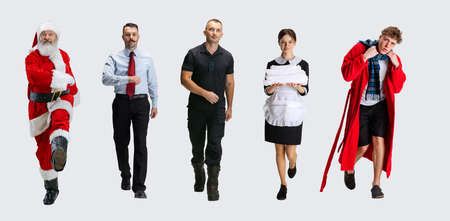Collage of different people walking in a line isolated on white background.の写真素材