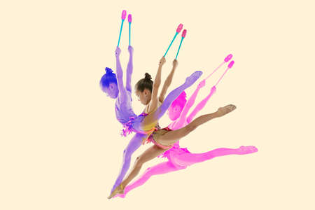 Creative collage of girl, professional rhytmic gymnast training with clubs isolated over white background. Glitch and duotine effectの写真素材