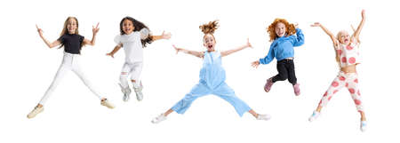 Collage of five cheerful, happy girls, children jumping isolated over white backgroundの写真素材