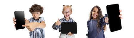 Collage of three kids, children, boy and two girls pointing on phone screen isolated over white...