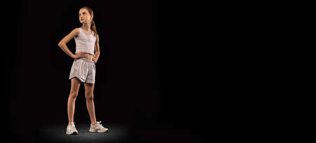 Full-length portrait of proudly looking teen girl, professional athlete, runner posing isolated over...