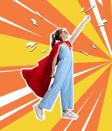 Contemporary art collage, creative design of little girl wearing red cloak and standing like superhero isolated over orange yellow backgroundの写真素材