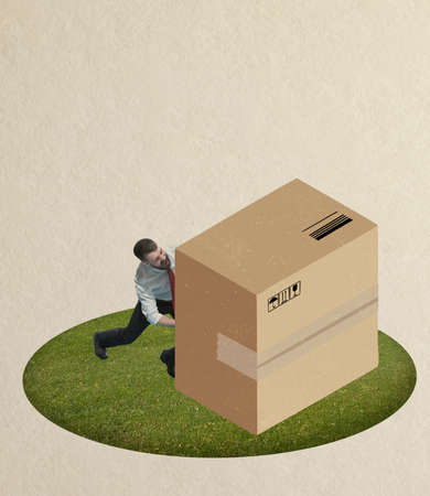 Contemporary art collage of man pushing heavy and huge cardboard box isolated over beige backgroundの写真素材