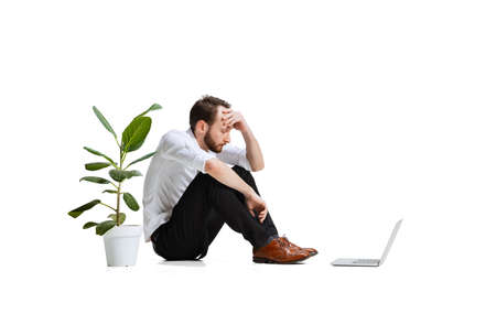 Full-length portrait of thoughtful man, employee thinking on difficult business project isolated...