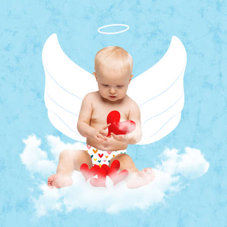 Creative art collge. Little girl, toddler in character of love angel looking at hearts, sitting on cloud isolated over blue backgroundの写真素材