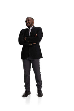 Full-length portrait of businessman with dissatisfied facial expresion due unpleasant project results isolated over white backgroundの写真素材