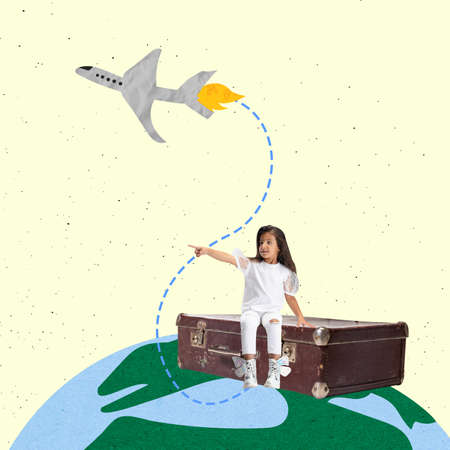 Creative colorful design with little girl, child sitting on vintage suitcase and dreaming about travellingの写真素材