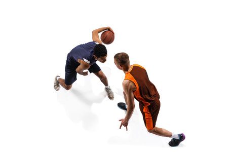 Top view portrait of two men, professional basketball players in motion, training isolated over white studio background. Defending. Concept of sport, team game, action, active lifestyle, adの写真素材