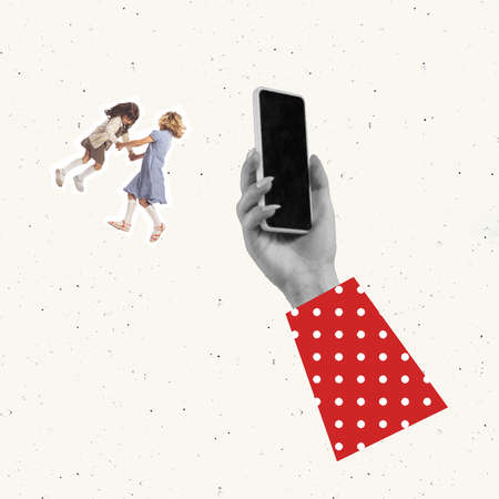 Contemporary art collage. Conceptual image. Womans hand recording video of two girls, children dancing, having fun. Making memories. Concept of childhood, help, education, retro artwork styleの写真素材