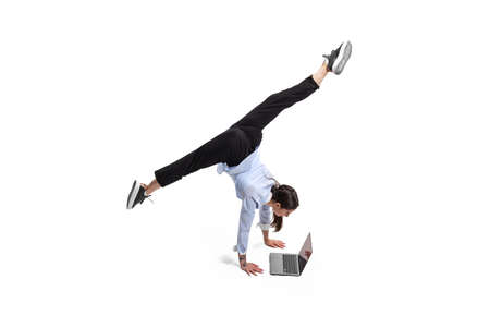 Portrait of female office worker standing on twine and making business notes isolated over white studio background. Concept of business, office lifestyle, success, ballet, career, expression, adの写真素材