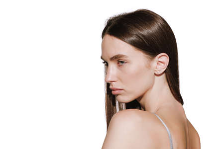 Side view portrait of beautiful young girl isolated over white background. Cosmetic procedures, beauty injections. Concept of beauty, natural skin, cosmetology, spa, plastic sugery. Copy space for adの写真素材