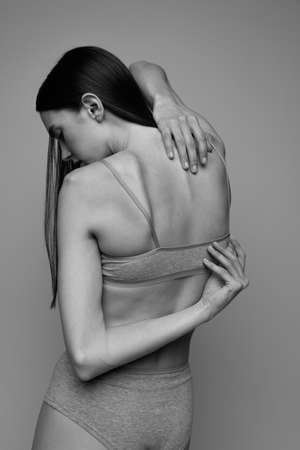 Side view portrait of slender young woman posing in lingerie. Black and white photography. Tenderness. Concept of natural beauty, body and skin care, femininity, self-acceptance, adの写真素材