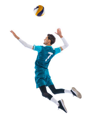 Portrait of young man, volleyball player in motion, training, playing isolated over white studio background. In a jump. Concept of sport, action, team game, active lifestyle, health, hobby, adの写真素材
