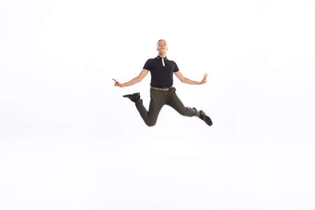 Portrait of young man in stylish black outfit posing isolated over white studio background....