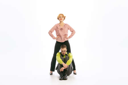 Portrait of young stylish man and woman posing together isolated over white background. Dream team....