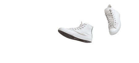 Casual, stylish, white gumshoes, sneakers isolated over white studio background. Flyer. Concept of comfortable fashion, style, shopping, casual. Copy space for ad, text and designの写真素材