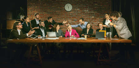 Group of people, active employees lively taking, discussing and arguing according current business questions. Different points of view. Concept of business, career, team, brainstorming. Indoor officeの写真素材