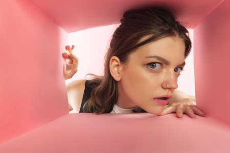 Close-up image of young girl looking inside open carton box. Receiving shopping packages. Delivery...