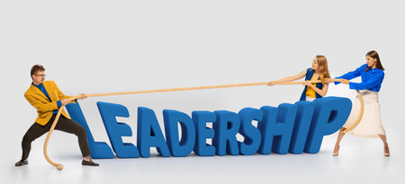 Motivated, ambitious people pulling the rope symbolizing professional competition. Women against man. Concept pf personal and professional growth, success, win, employmentの写真素材