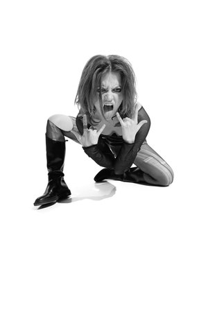 Portrait of young expressive woman, rock music lover posing over white background. Black and white photography. Concept of music, rock and roll, lifestyle, fashion. Copy space for ad, textの写真素材
