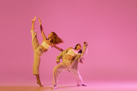 Modern dance art. Young girls, couple of dancers in sports style clothes dancing experimental dances...