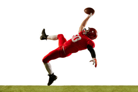 Professional american football player in sports uniform and protective helmet in action isolated over white background. Concept of active life, team game, energy, sport, competition. Copy space for adの写真素材