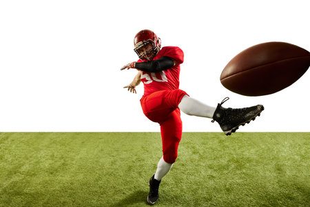Professional american football player in sports uniform and protective helmet in action isolated over white background. Concept of active life, team game, energy, sport, competition. Copy space for adの写真素材