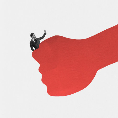 Huge drawn fist holding man. Contemporary art collage. Minimalism. Ideas, inspiration, motiovation. Concept of business, personal and professional growth, human rights, freedomの写真素材