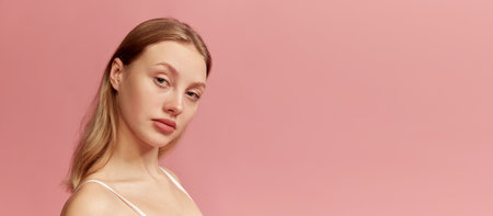 Portrait of young beautiful girl without makeup on face. Model with long healthy blonde hair looking...