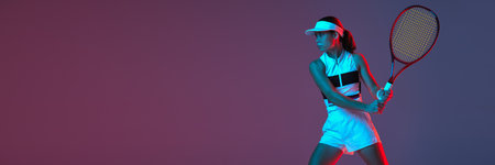 Young professional emotional tennis player in sports uniform in action over gradient pink-purple background in neon light. Sport, fashion, energy, motivation concept. Banner with copy space for adの写真素材
