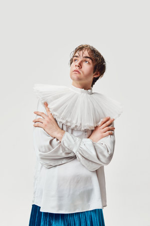 Thoughtful look. Fashion portrait of stylish high fashionable boy posing isolated over grey background. Masculinity and femininity. Concept of modern fashion, uniqueness, adの写真素材