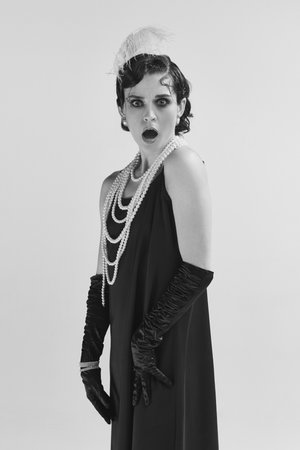 How you dare. Closeup portrait of shocked woman wearing old-time clothes standing and looking with...
