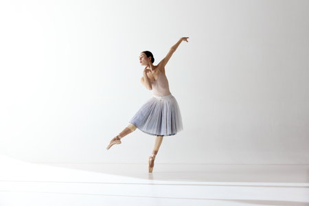 Graceful ballerina, ballet. Beautiful woman ballet dancer dancing over white background. Art, motion, action, flexibility, inspiration concept. Beauty of contemporary danceの写真素材