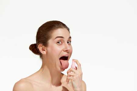 Fresh breath. Shot of one young girl, woman disinfect mouth with unpleasant facial expression over...