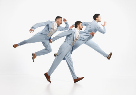 Going on important business. Serious men wearing elegant suit hurry up over white background. Concept of historical remake, comparison of eras, vintage, business, ad, fashion, mood, emotion, adの写真素材
