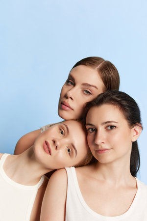 Beauty injections. Portrait of young beautiful girls without makeup on face looking at camera over blue studio background. Concept of skin care, spa, anti-aging procedures, plastic surgery, adの写真素材