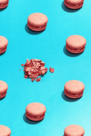 French almond cookies on dessert top view. Food pattern with macaroons over blue background flat lay top-down composition. Find the difference. Concept of food, diet, ad. Usable for wallpaper, designの写真素材