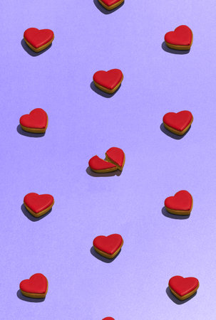 Cookies in the shape of heart on dessert top view. Food pattern with sweet bakery over violet background flat lay top-down composition. Find the difference. Concept of food, diet, cooking, design, adの写真素材