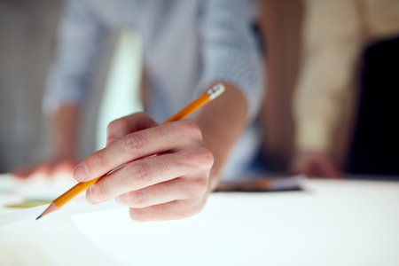Close up image with one business man, startup owner holding pencil and working on a new project over...