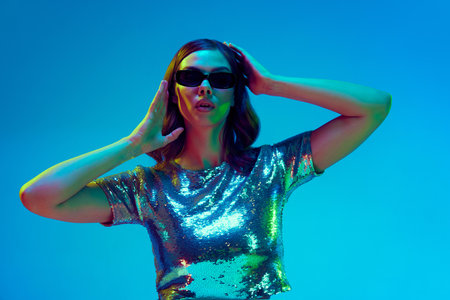 Beautiful fashion model, dreaming woman wearing fashionable clothes, silver top and black sunglasses...
