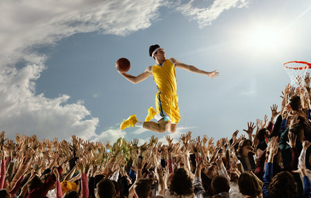 Sport collage with basketball player with ball in hands jumping high over hands of fans scoring a goal. Concept of sport, victory, bascketball, fans, support, healthy lifestyle, hobby.の素材 [FY310209379038]