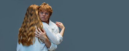 Support and understanding. Handsome redhead man hugging woman and looking at camera Concept of natural beauty, love, relationships, fashion. Copyspace for ad. Bannerの写真素材