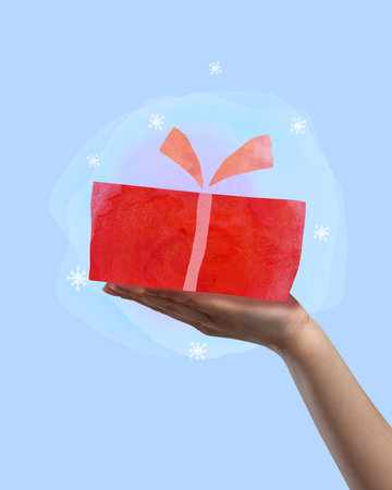 Contemporary art collage. Contemporary art collage. Hand holding New Year gift isolated over blue background. Happy holidays. Concept of Christmas, New Year, holiday, celebration, winter. Bannerの写真素材