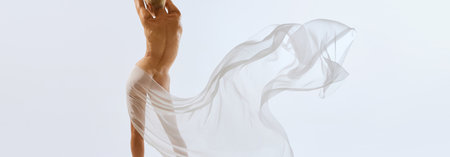 Back view. Cropped portrait of young sensual nudity female body, buttocks covering with floating on air transparent fabric. Concept of natural beauty of body, feminine energy, art. Ad. bannerの写真素材