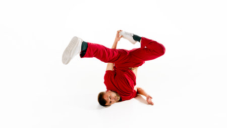 Fashionable portrait. Stylishly dressed young man dancing in freestyle, breakdance style in motion...