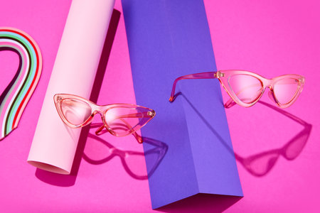 Optic store discount poster. Trendy sunglasses on bright pink color scheme background with geometric figures. Trendy Fashion summer accessories. Concept of beauty, trends, Minimalism. Copy space. Adの写真素材