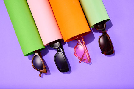 Poster. Top view close up photo of trendy sunglasses on bright colorful background. Trendy Fashion summer accessories. Concept of beauty, trends, sales, shopping. Black Friday. Copy space for text. Adの写真素材