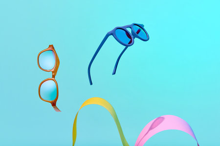 Poster. Optic store discount. Photo of flying sunglasses against vivid blue background with colorful decorative elements. Trendy accessories. Concept of glamour, style, fashion, shopping. Copy space.の写真素材